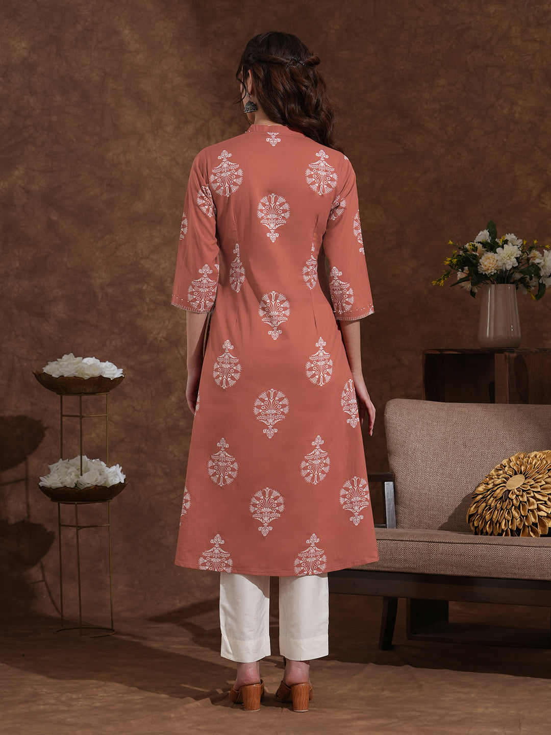A-line cotton print kurta in rust orange color with beadwork and pocket.
