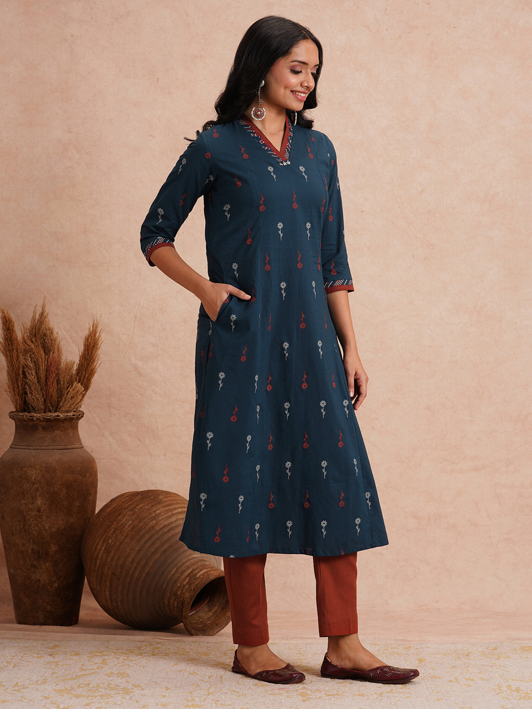 Printed A-line kurta with contrast fabric detailing with mirror work.