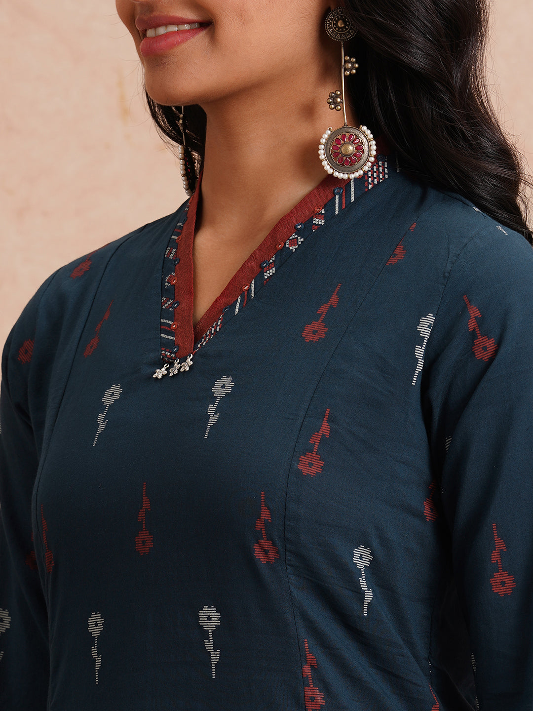 Printed A-line kurta with contrast fabric detailing with mirror work.