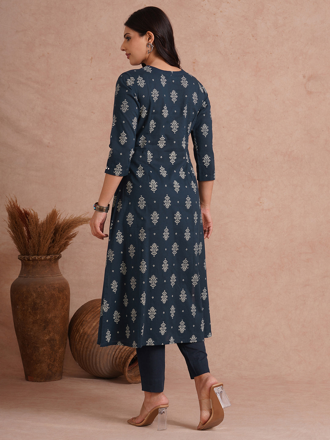A-line kurta with tucks and box pleat in the front highlighted with handwork mirrors.