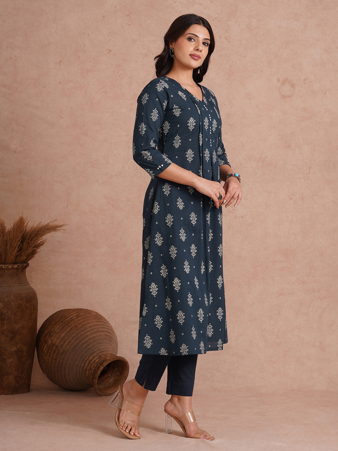A-line kurta with tucks and box pleat in the front highlighted with handwork mirrors.