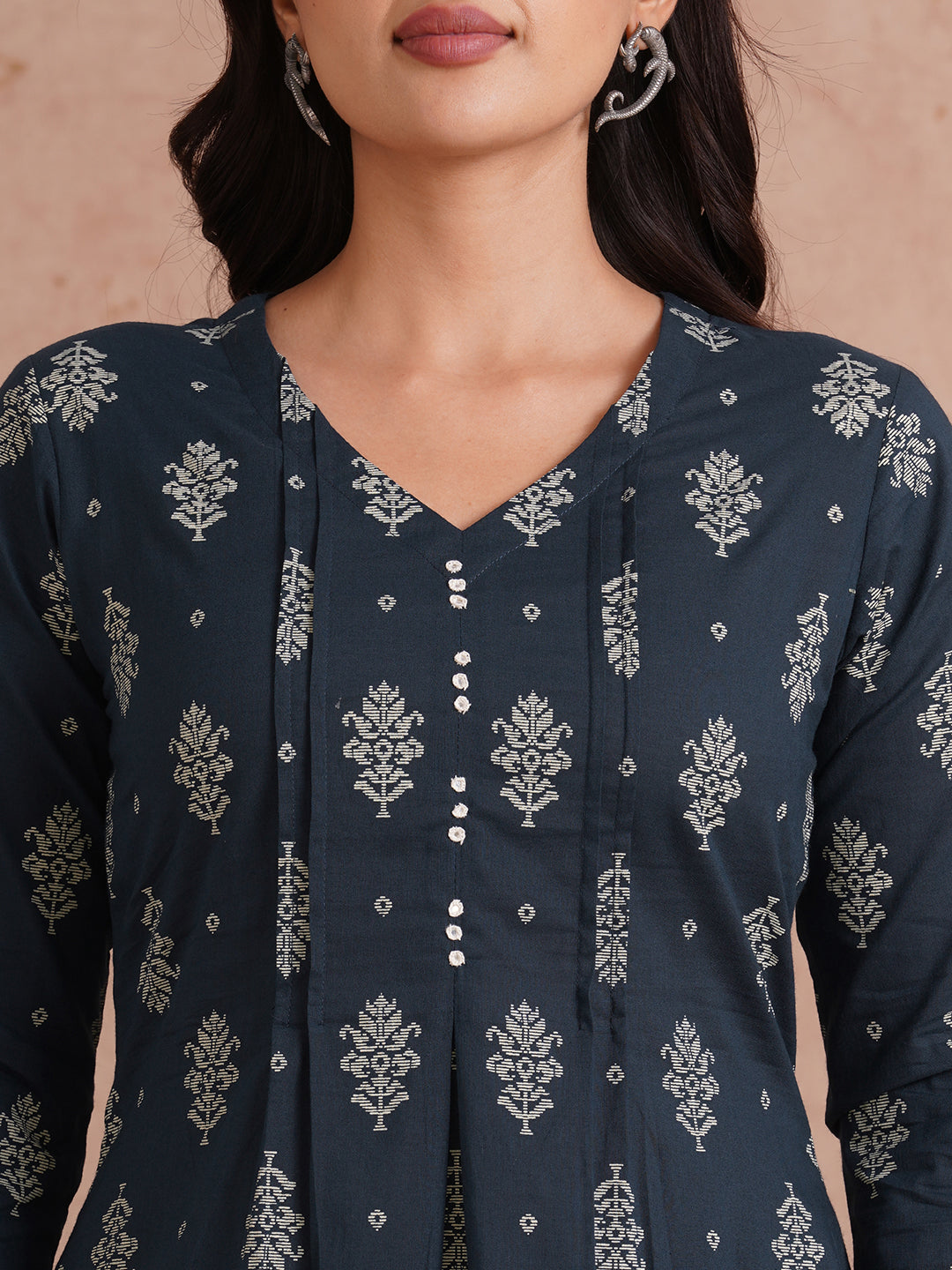 A-line kurta with tucks and box pleat in the front highlighted with handwork mirrors.