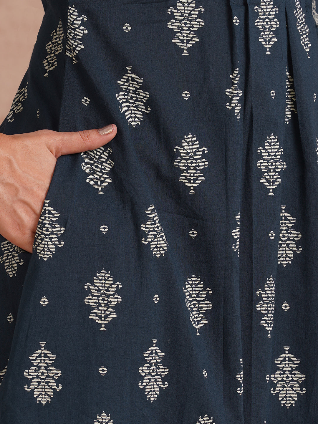 A-line kurta with tucks and box pleat in the front highlighted with handwork mirrors.