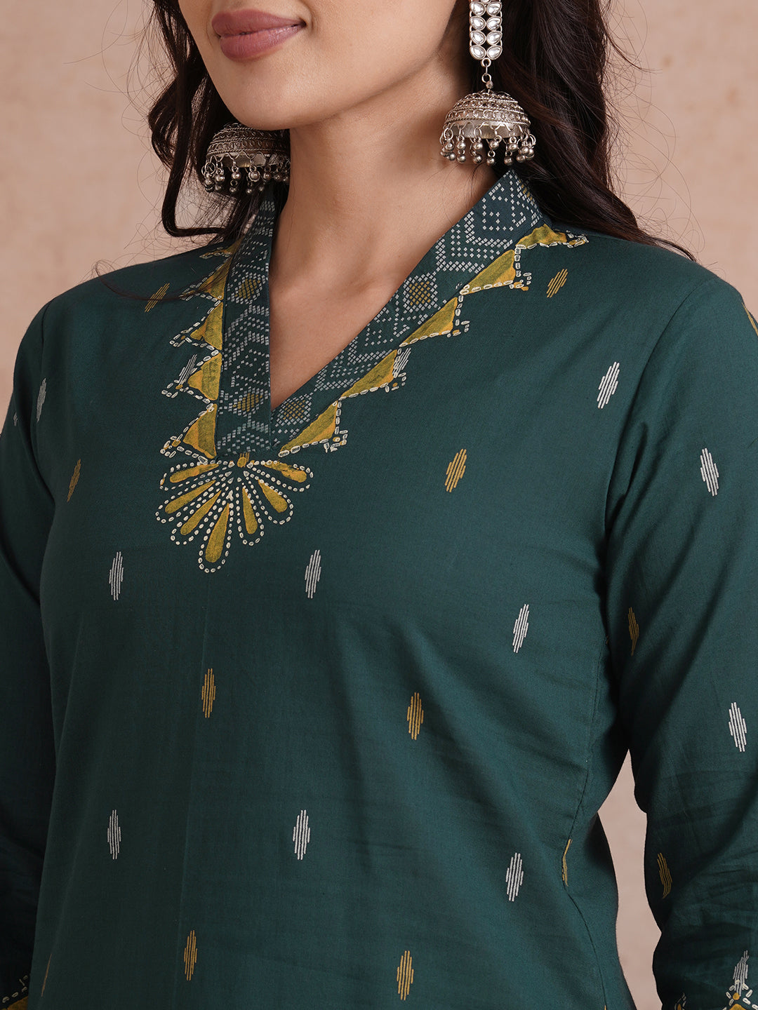 Straight fit cotton printed kurta with block printed neckline and sleeves.