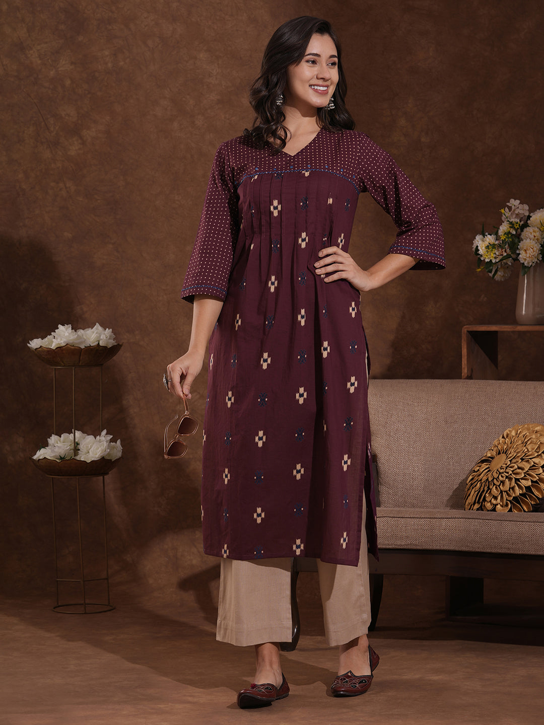Printed straight fit kurta with shoulder yoke and tucks highlighted with handwork on yoke and sleeves.