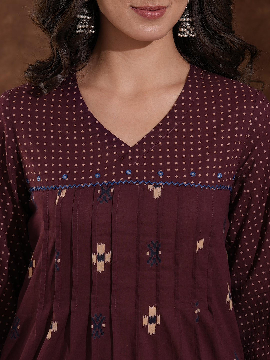 Printed straight fit kurta with shoulder yoke and tucks highlighted with handwork on yoke and sleeves.