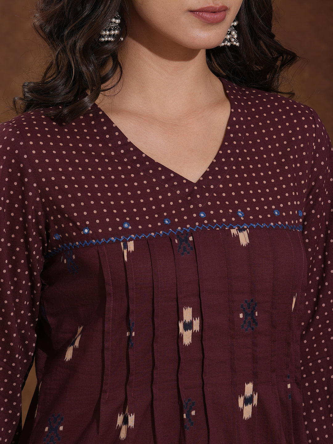 Printed straight fit kurta with shoulder yoke and tucks highlighted with handwork on yoke and sleeves.