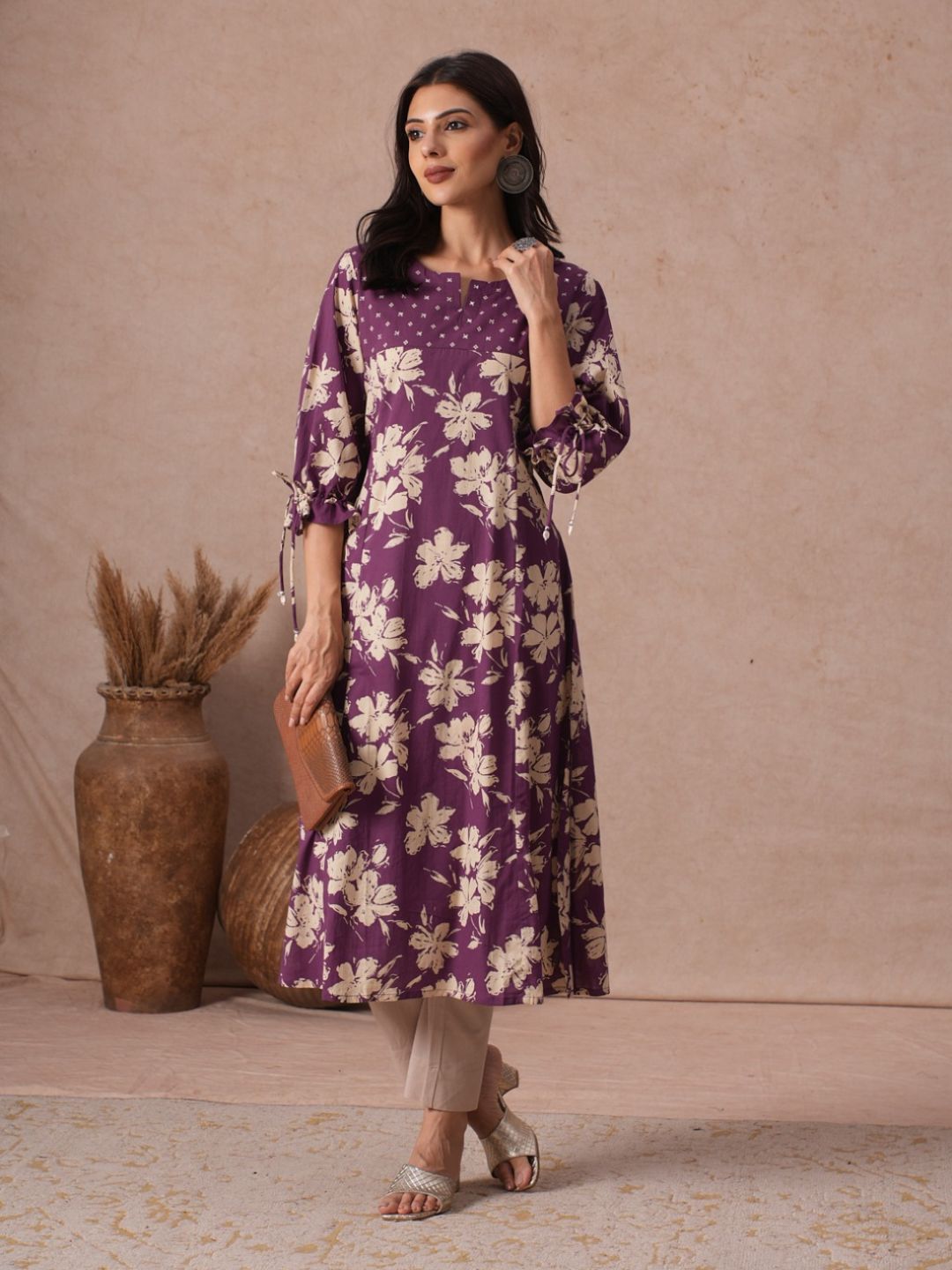 A-line Printed Cotton Kurta with Hand Sequined Yoke and Stylish Tie-Up Sleeves.