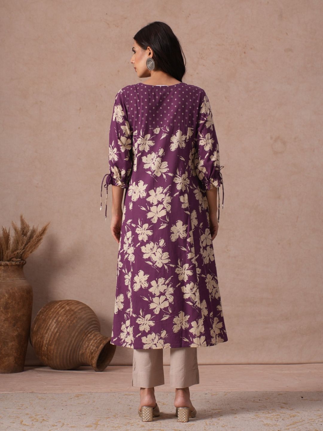 A-line Printed Cotton Kurta with Hand Sequined Yoke and Stylish Tie-Up Sleeves.