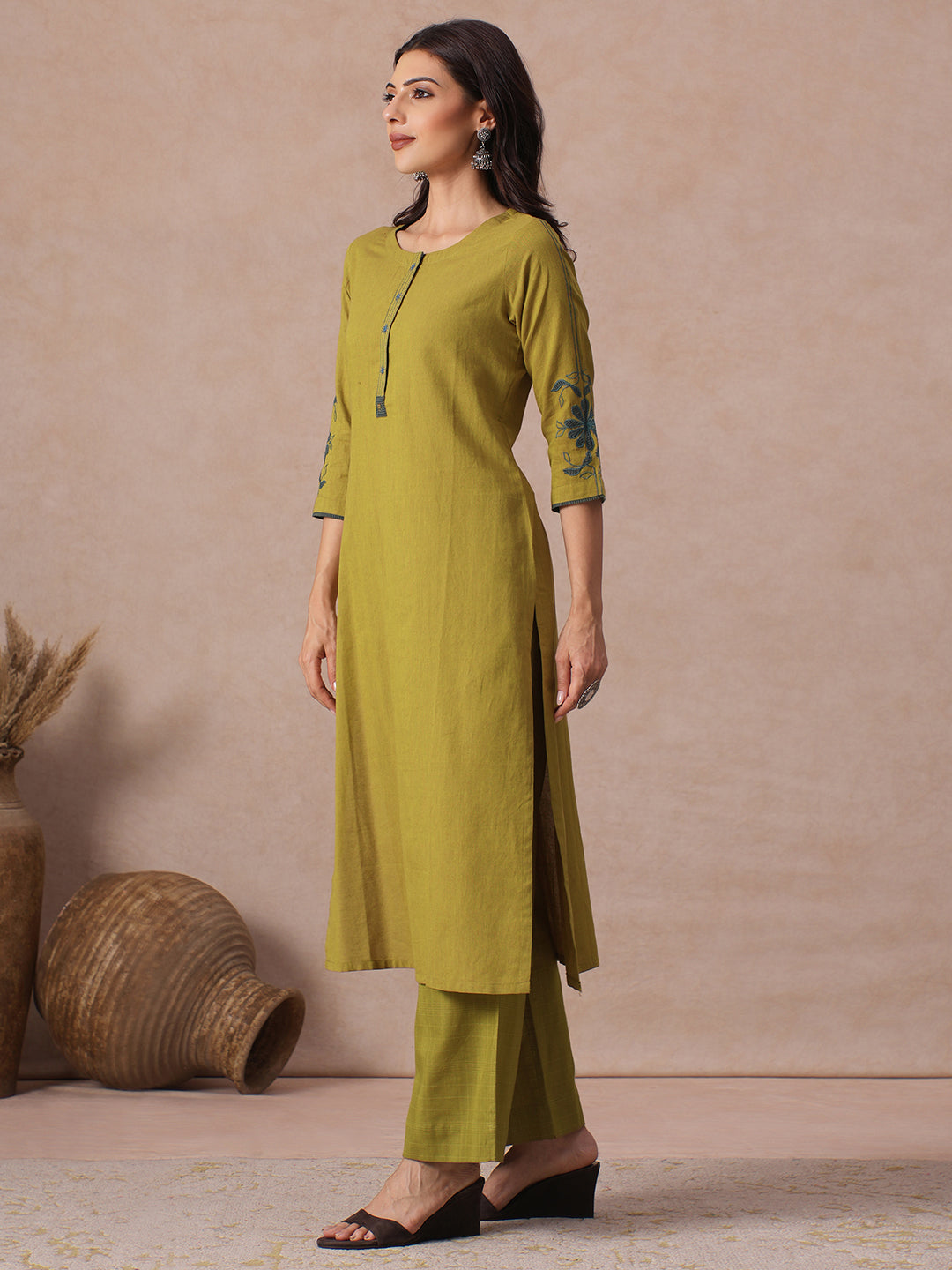 Straight Fit Cotton Kurta with Handwork Placket and Machine Applique Sleeve Detail.