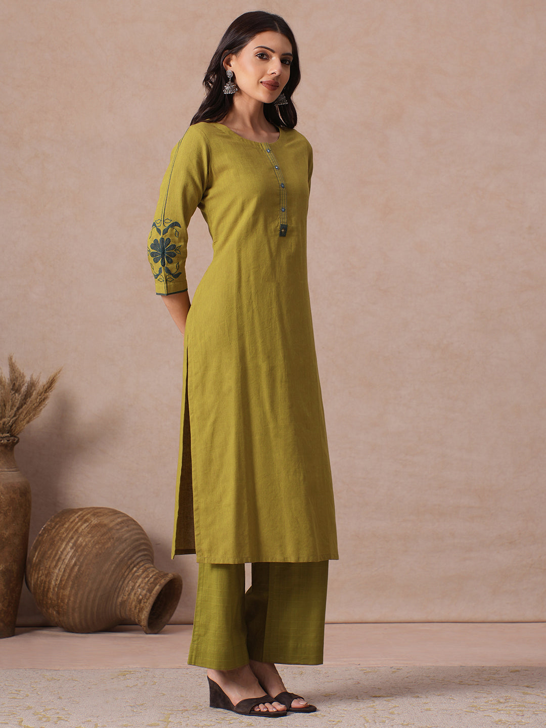 Straight Fit Cotton Kurta with Handwork Placket and Machine Applique Sleeve Detail.