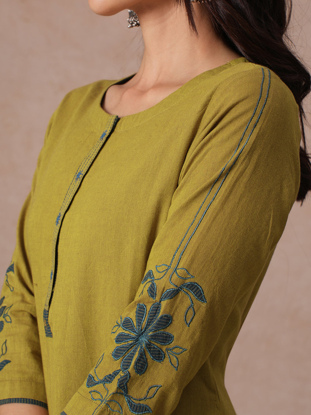 Straight Fit Cotton Kurta with Handwork Placket and Machine Applique Sleeve Detail.