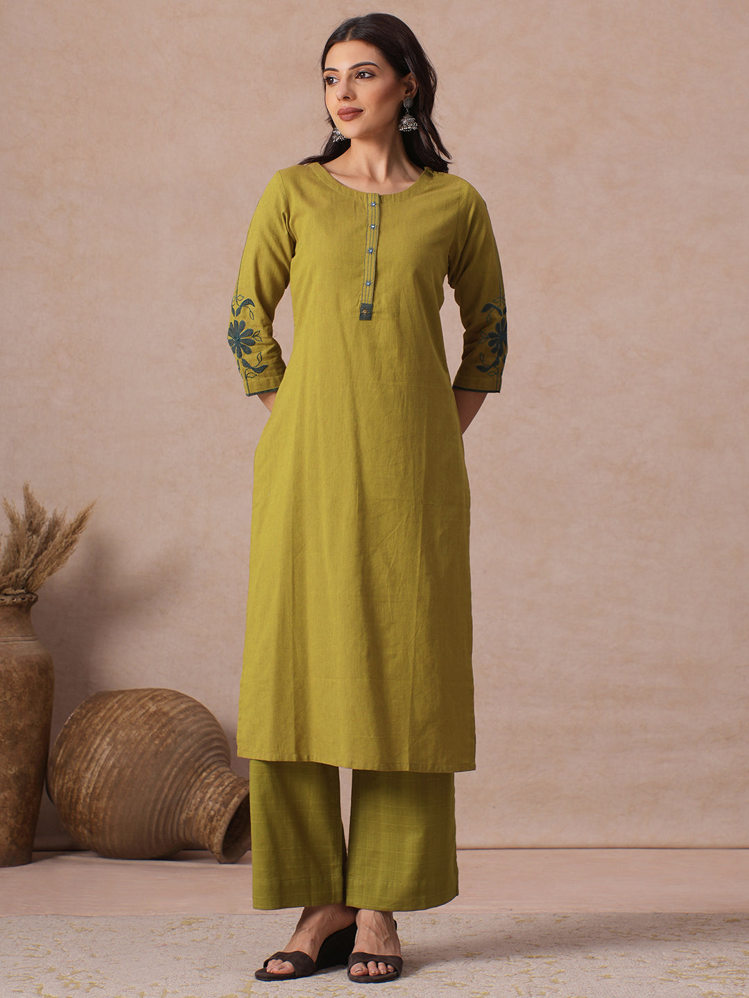 Straight Fit Cotton Kurta with Handwork Placket and Machine Applique Sleeve Detail.