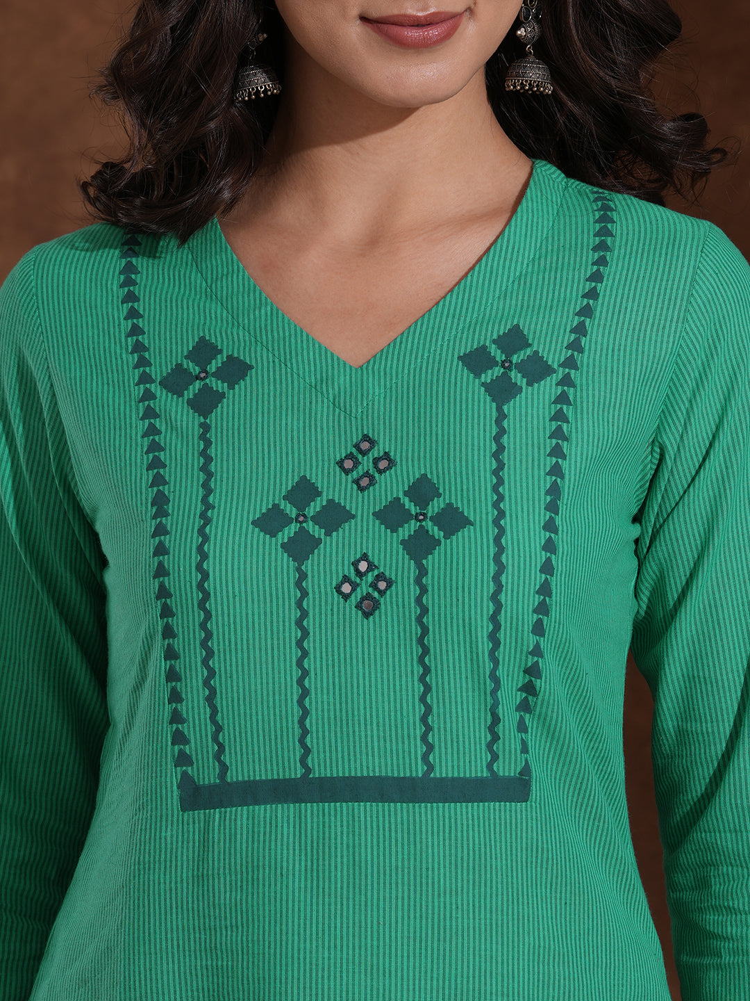 Straight fit kurta with block printed yoke and sleeves highlighted with handwork mirrors.
