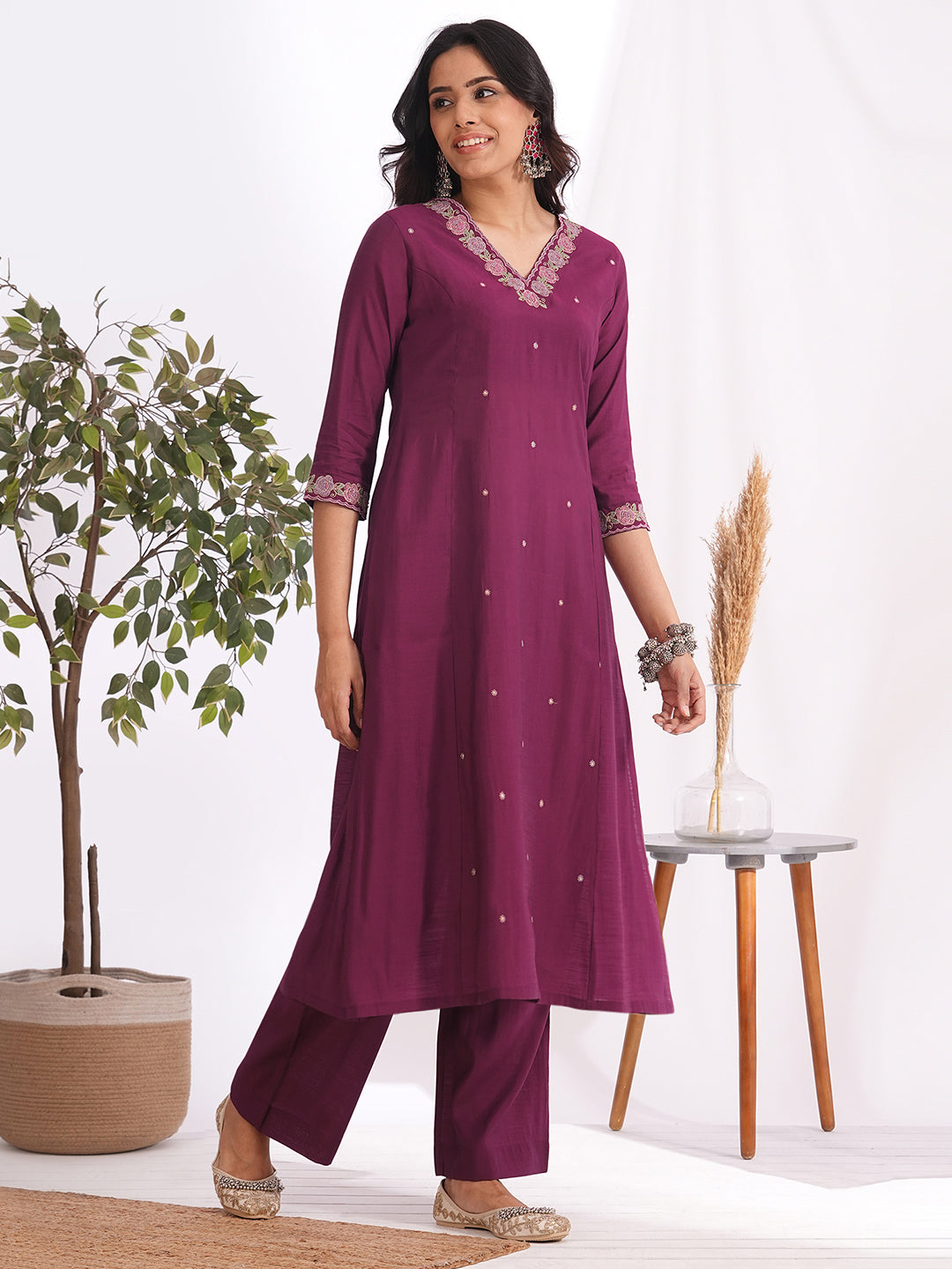 A-line kurta in silk blend fabric with thread and Zari embroidery paired with lined art silk palazzo