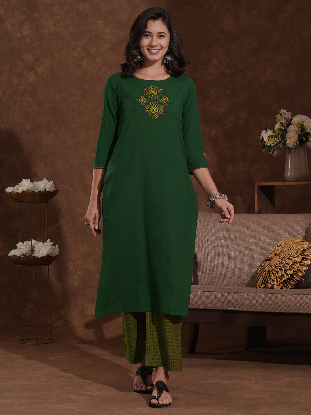 Straight fit kurta with Machine embroidery paired with woven checks palazzo.