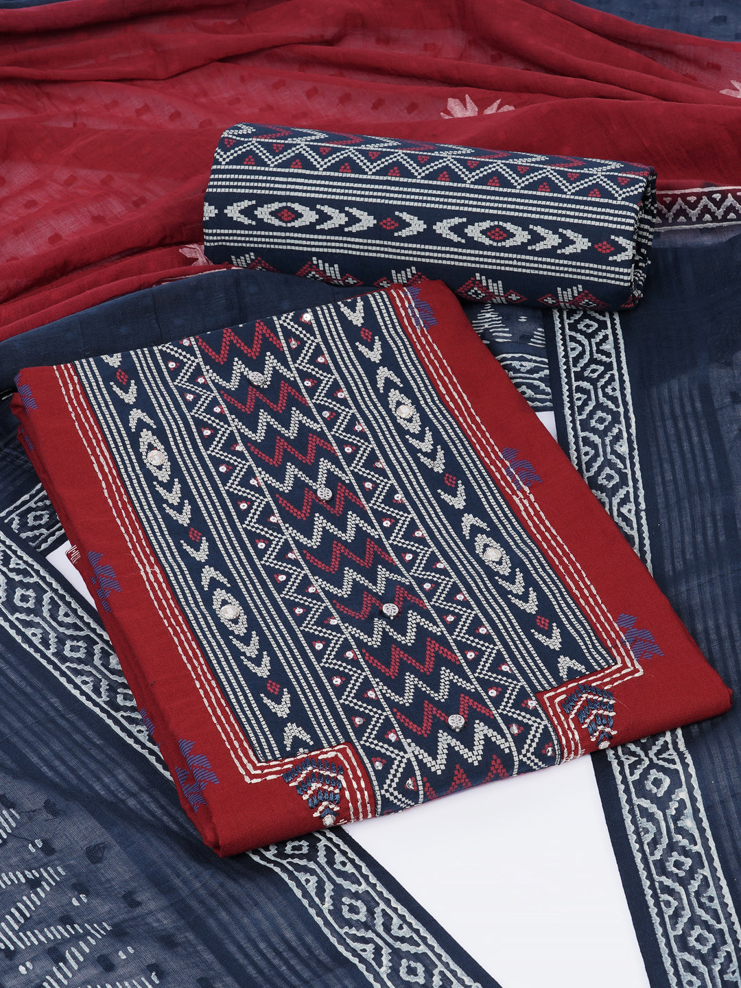 3-piece unstitched suit set featuring a butti-printed kurta with coordinated yoke detailing.