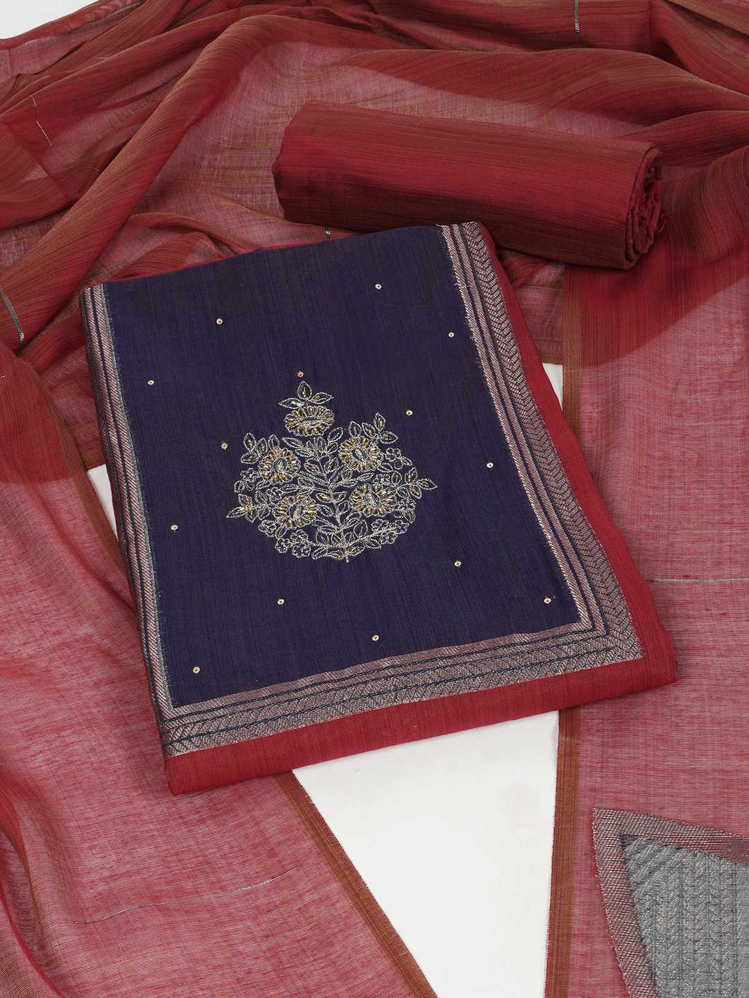 Unstitched suit set in elegant tussar silk featuring a contrast blue yoke with delicate zari work.(Maroon)