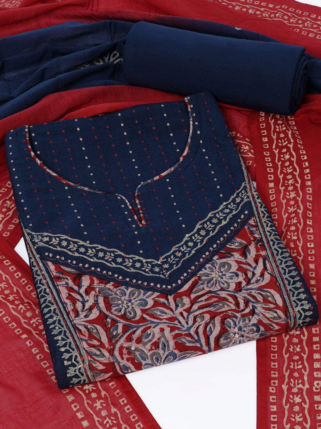 Unstitched suit set crafted in dobby fabric features a handcrafted Kalamkari printed patch.