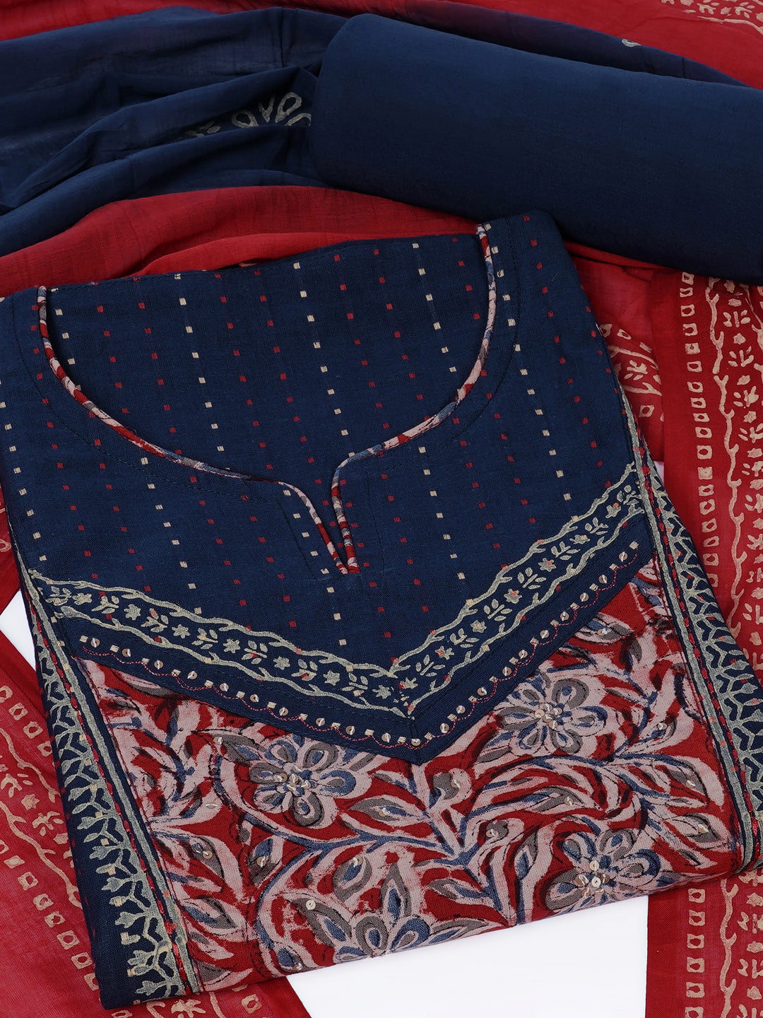 Unstitched suit set crafted in dobby fabric features a handcrafted Kalamkari printed patch.