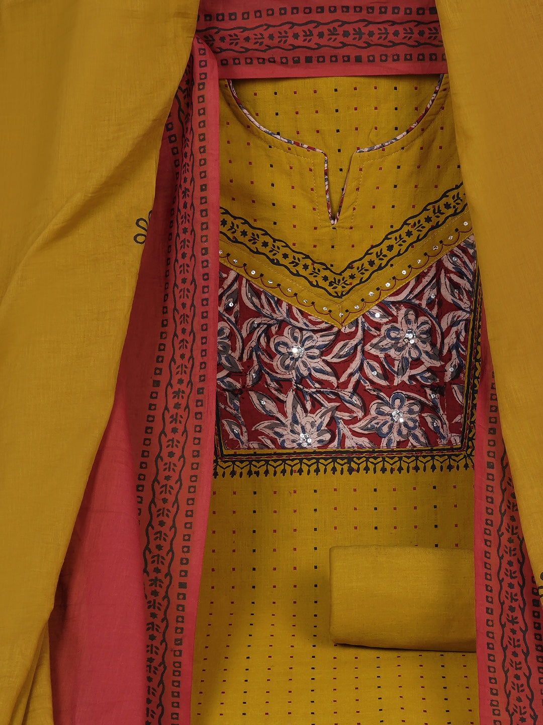 Unstitched suit set crafted in dobby fabric features a handcrafted Kalamkari printed patch.