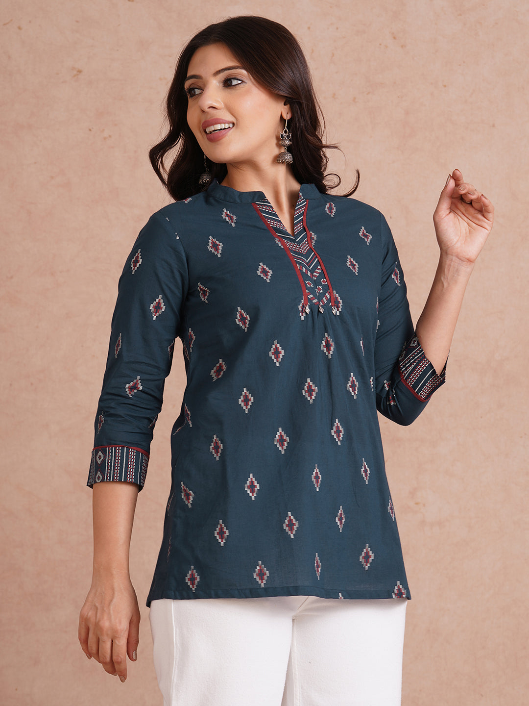 Printed short top with contrast fabric detailing with metal accessories.