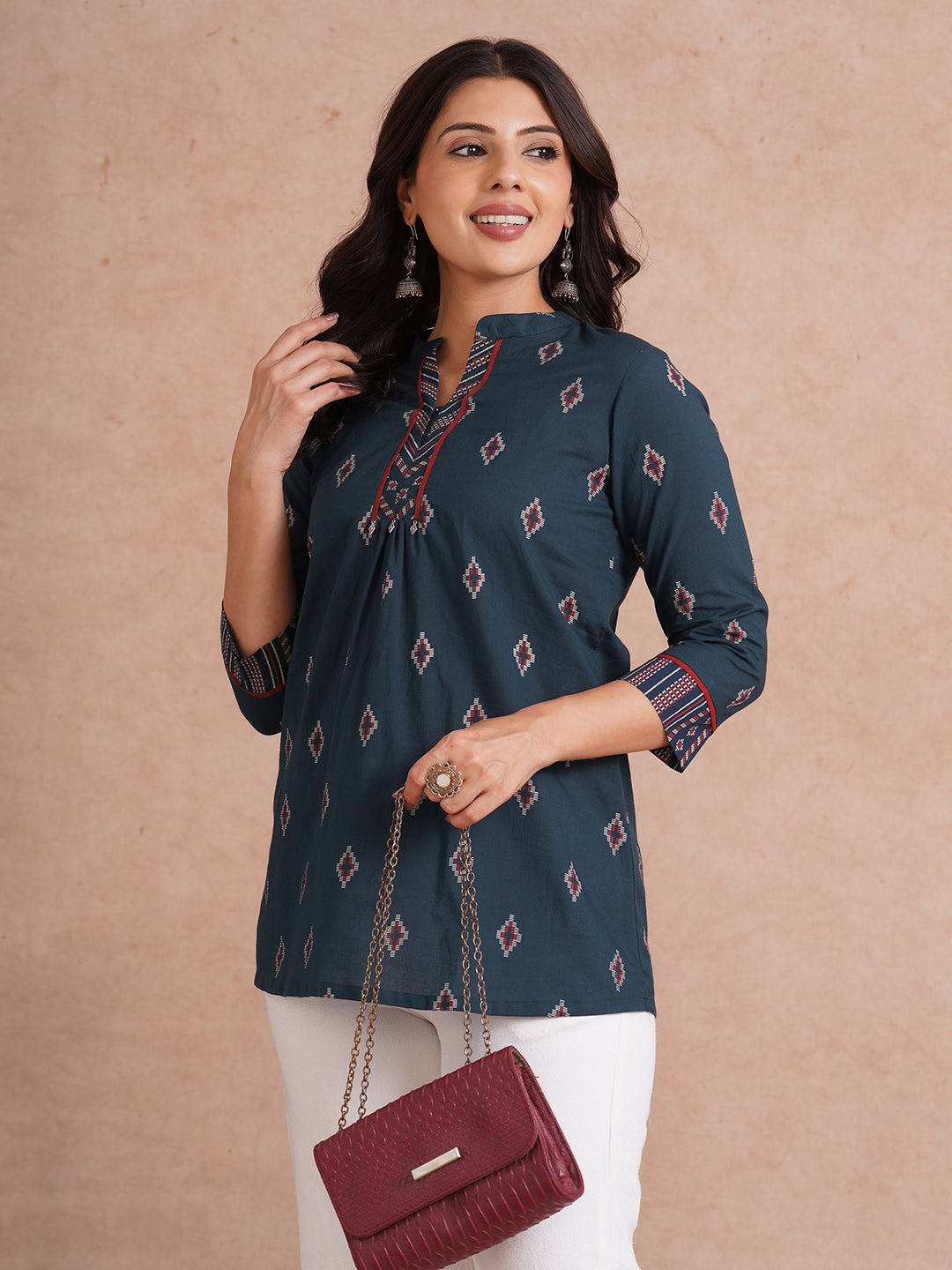 Printed short top with contrast fabric detailing with metal accessories.