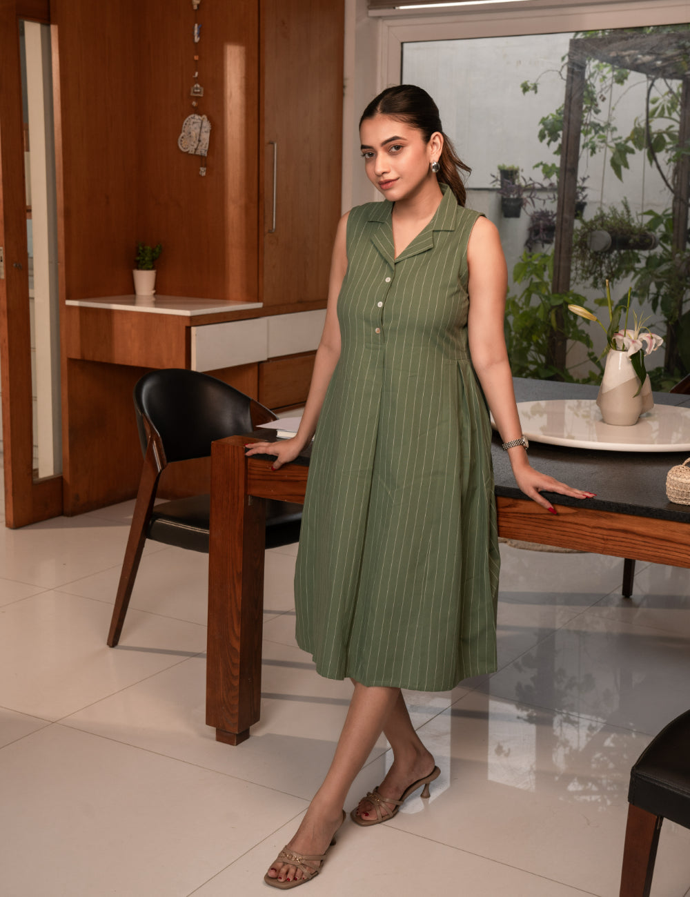 Striped sleeveless dress with notch collar and a side box pleat.