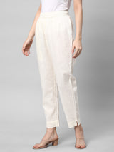 A fully elasticated off-white ankle length cotton linen pant.