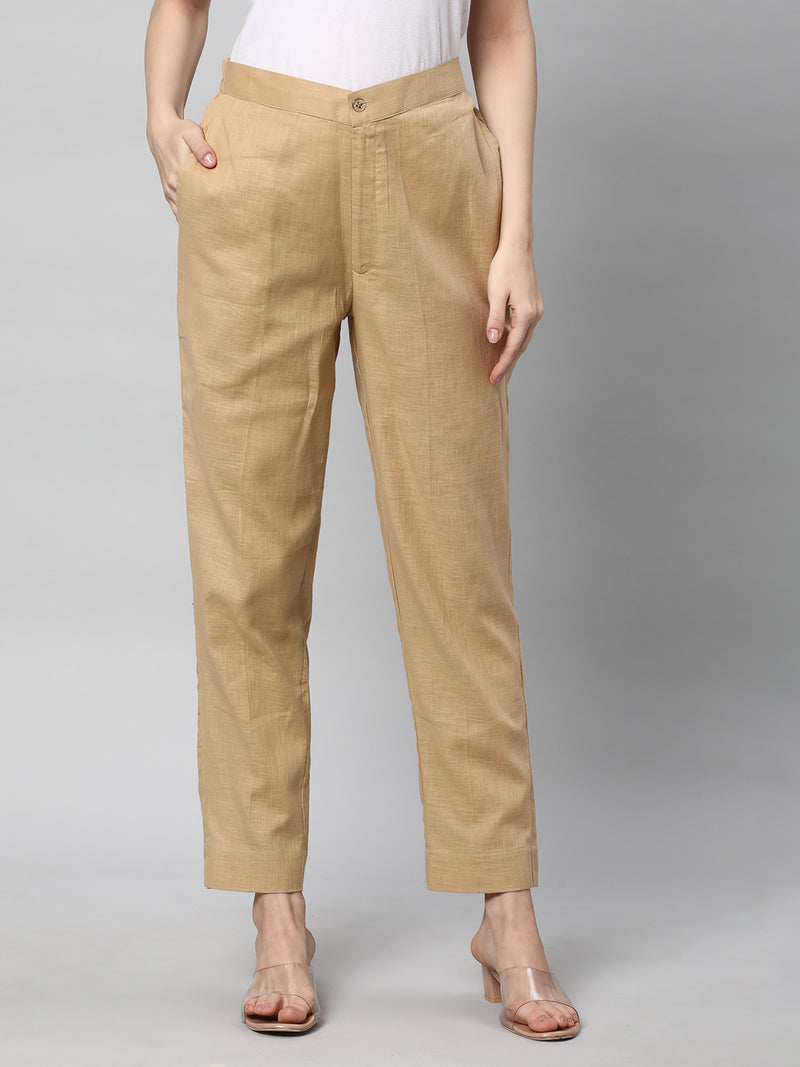 A beige ankle length cotton linen pant with plain belt in front.