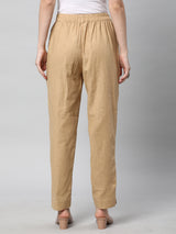 A beige ankle length cotton linen pant with plain belt in front.