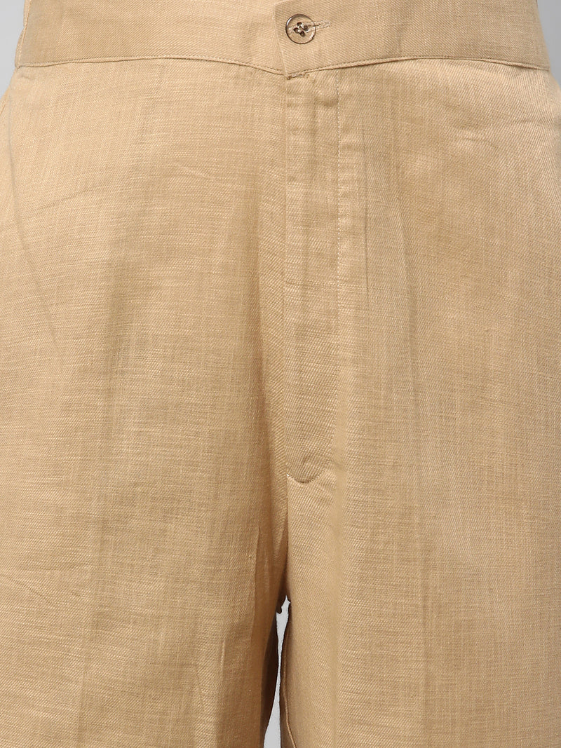 A beige ankle length cotton linen pant with plain belt in front.