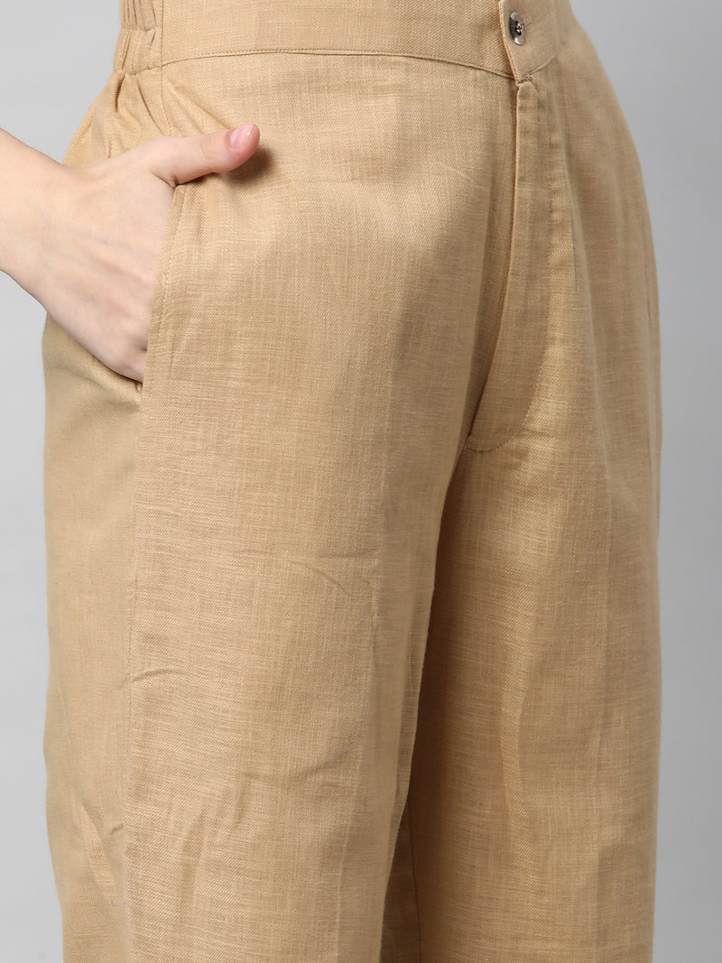 A beige ankle length cotton linen pant with plain belt in front.