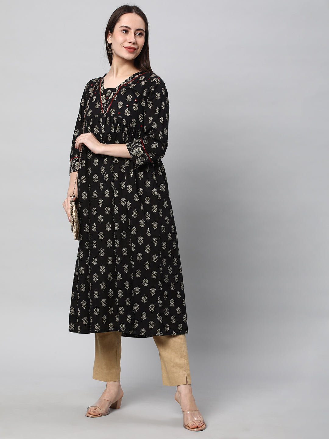 A beige ankle length cotton linen pant with plain belt in front