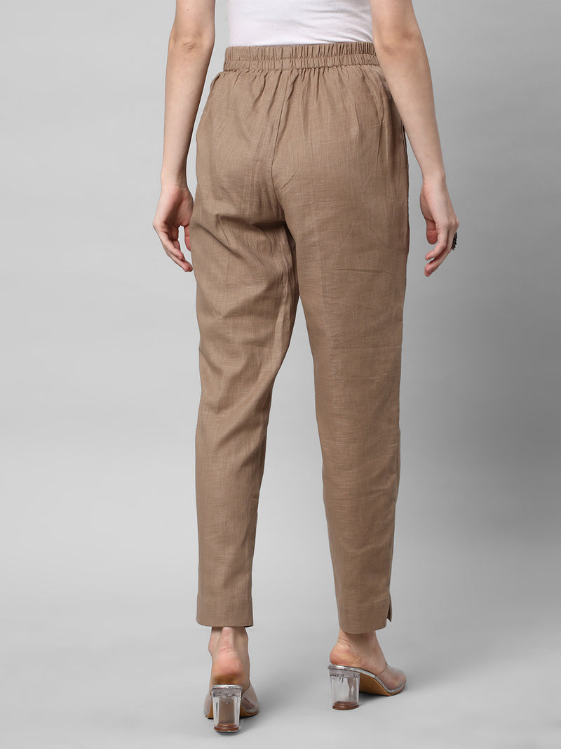 A brown ankle length cotton linen pant with plain belt in front.