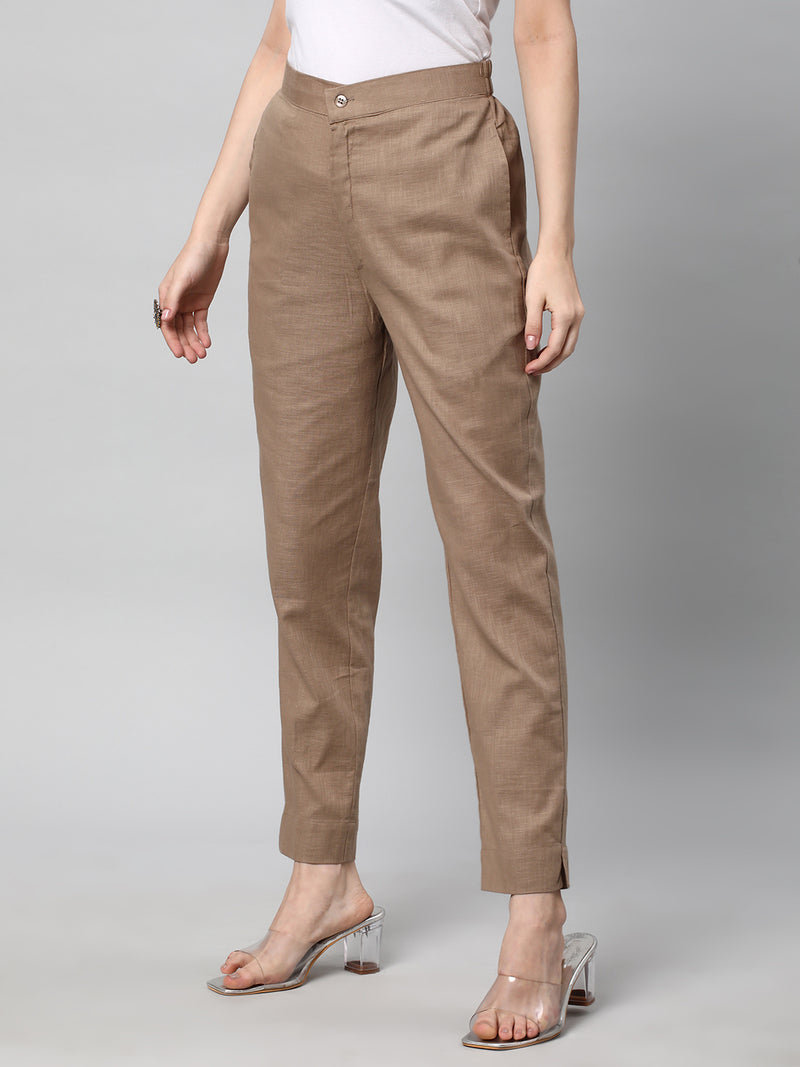 A brown ankle length cotton linen pant with plain belt in front.