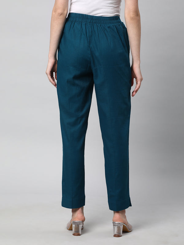 A Teal ankle length cotton linen pant with plain belt in front.