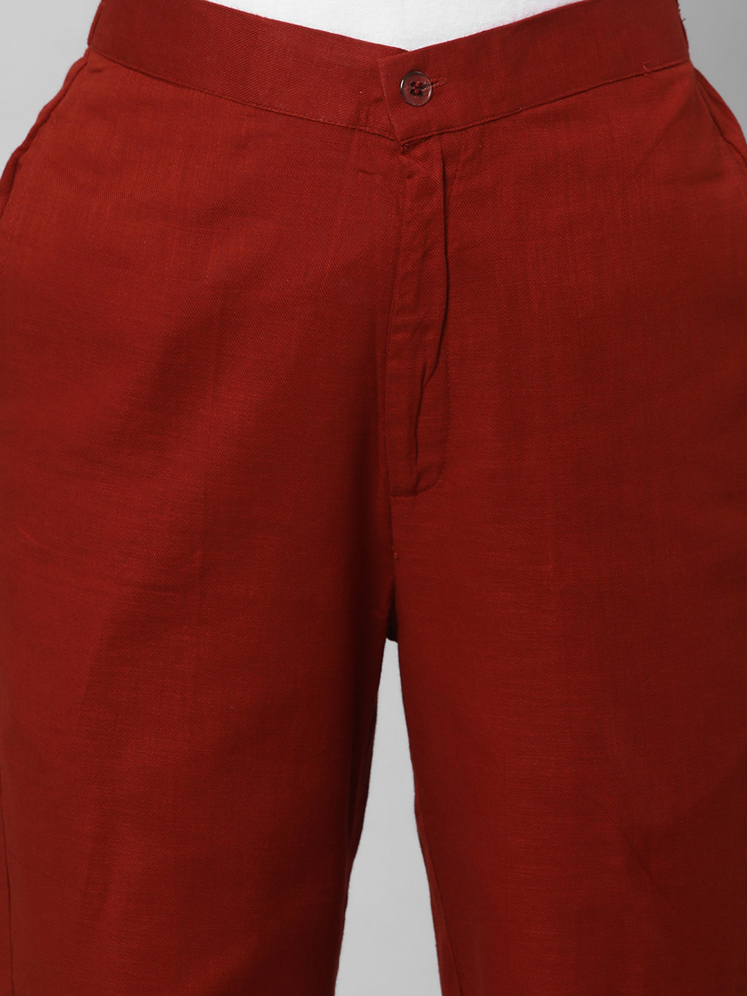A Rust ankle length cotton linen pant with plain belt in front