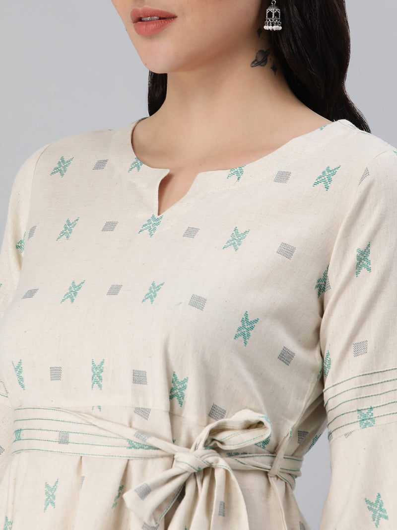 A flex flared tunic with pintucks and belt detail.