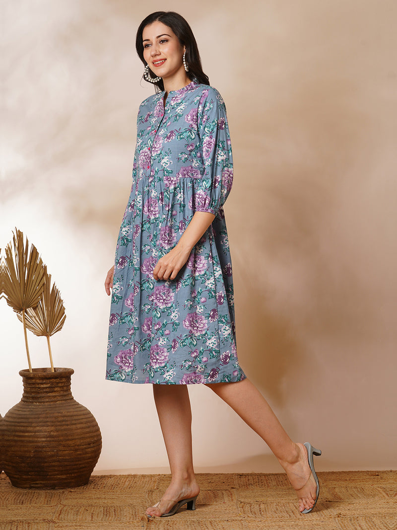 Fit and flared floral printed gathered dress with stand collar, placket and sleeve detailing.