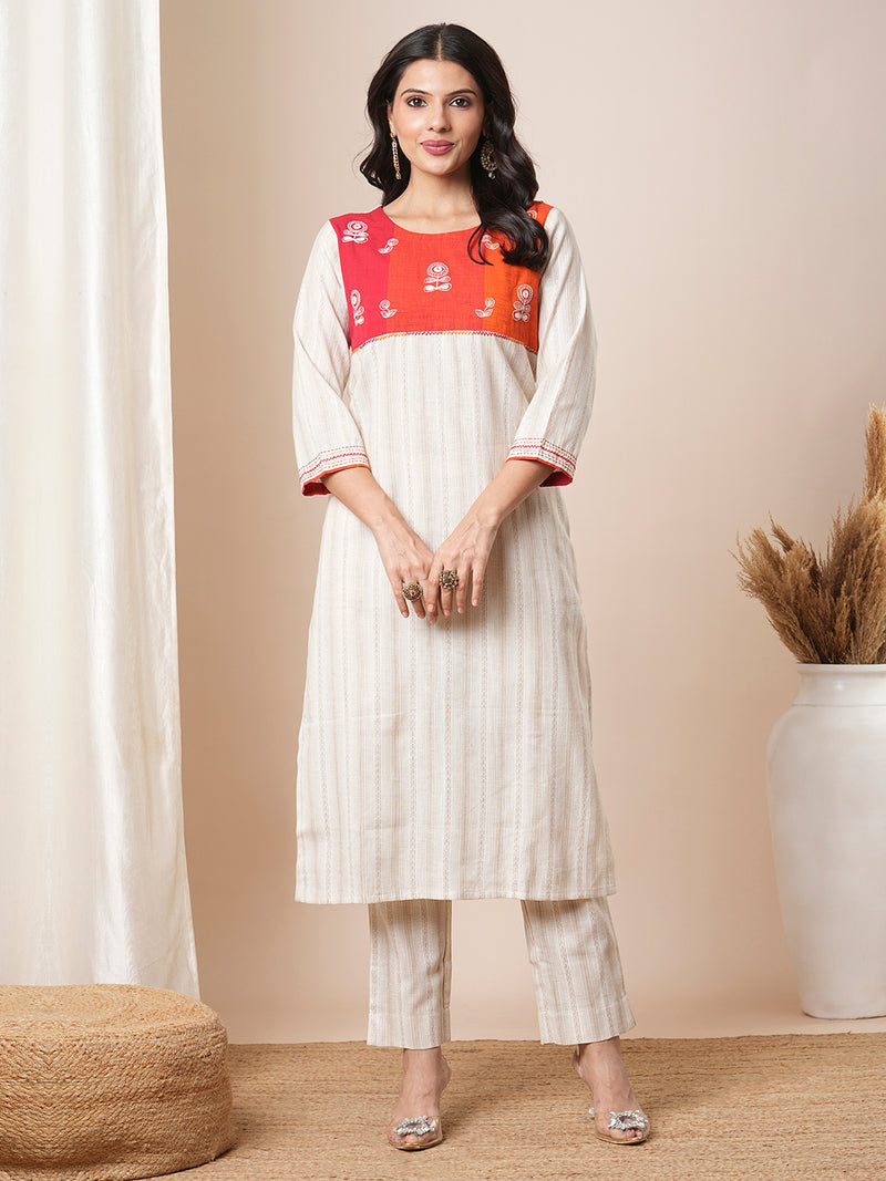 Straight kurta suit set features a handloom yoke embellished with dori work.