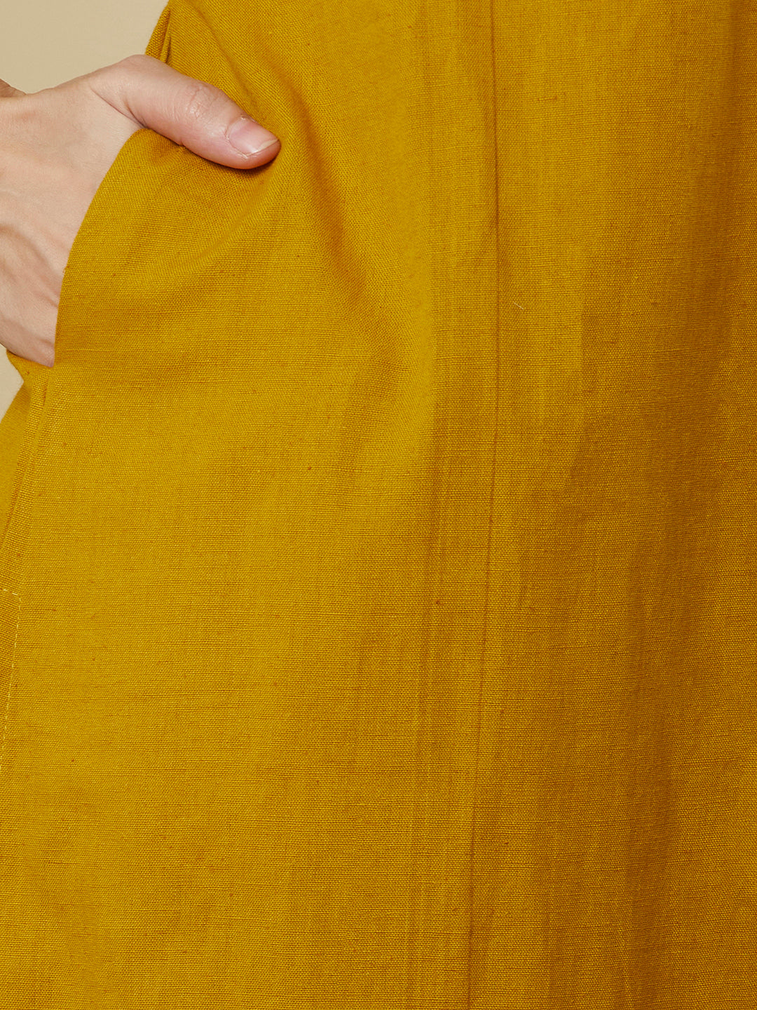 A mustard kurta suit set featuring a mix-match yoke and hand applique