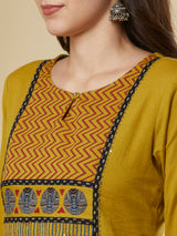 Mustard kurta suit set is paired with a printed bottom and a contrast color block-printed dupatta.