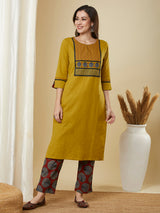 Mustard kurta suit set is paired with a printed bottom and a contrast color block-printed dupatta.