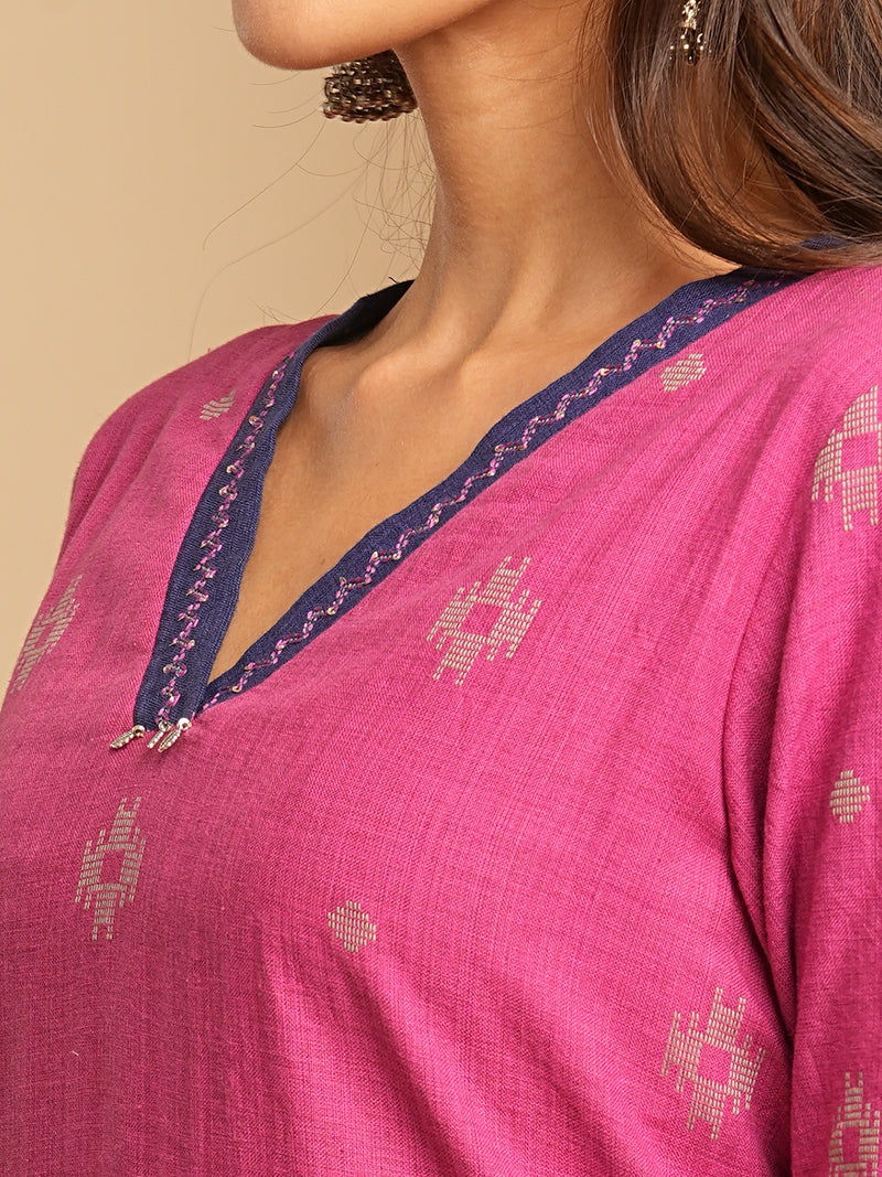 V-neck straight kurta with hand embroidery highlighted on the neckline Paired with double dye block printed  mull dupatta and straight pants.