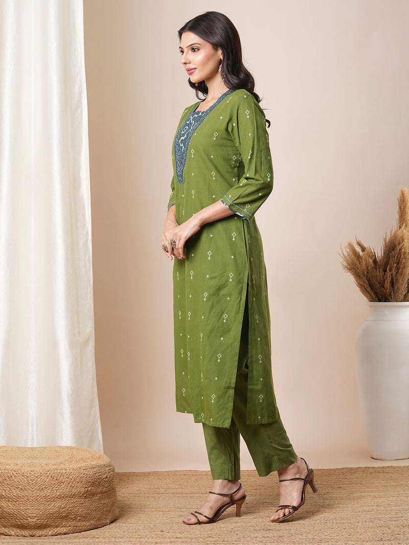 V-neck green dobby butti straight kurta suit set with floral dabu print yoke highlighted with handwork.