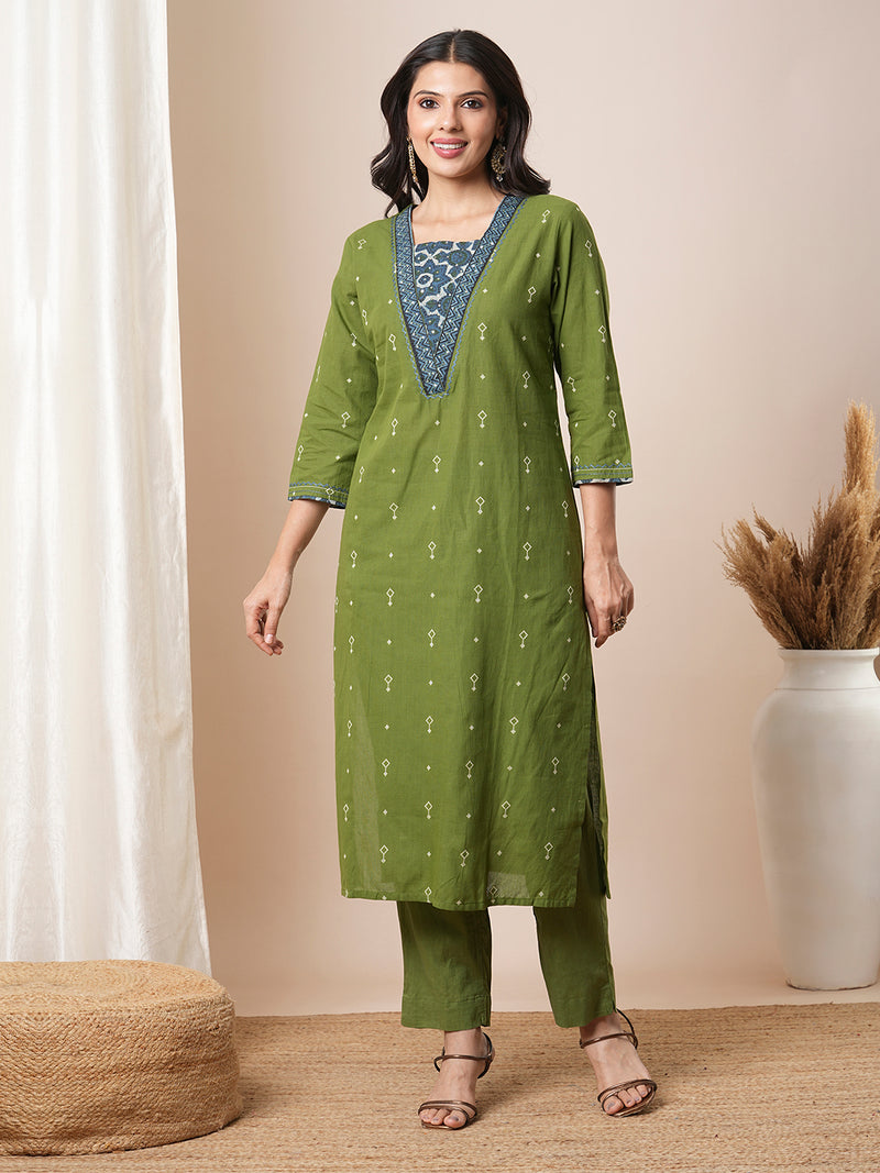 V-neck green dobby butti straight kurta suit set with floral dabu print yoke highlighted with handwork.