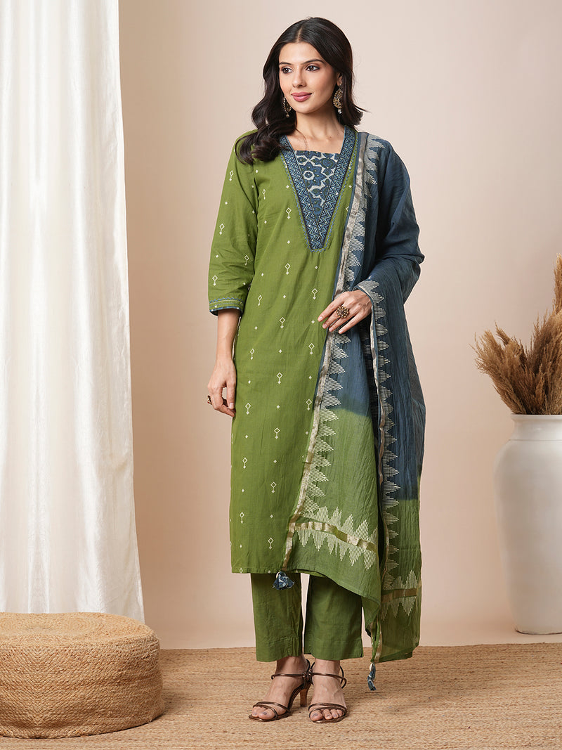 V-neck green dobby butti straight kurta suit set with floral dabu print yoke highlighted with handwork.