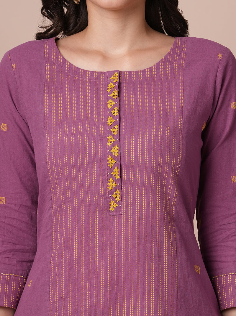 Pocketed A line kurta in cotton dobby fabric with hand embroidery.