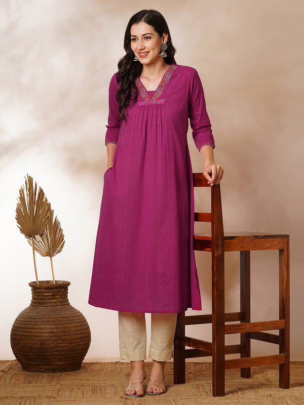 A-line woven cotton kurta with vibrant thread embroidery and gathering.